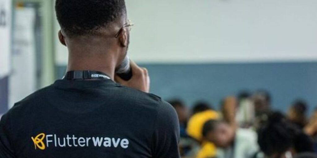 A Flutterwave staff speaks to a group of people